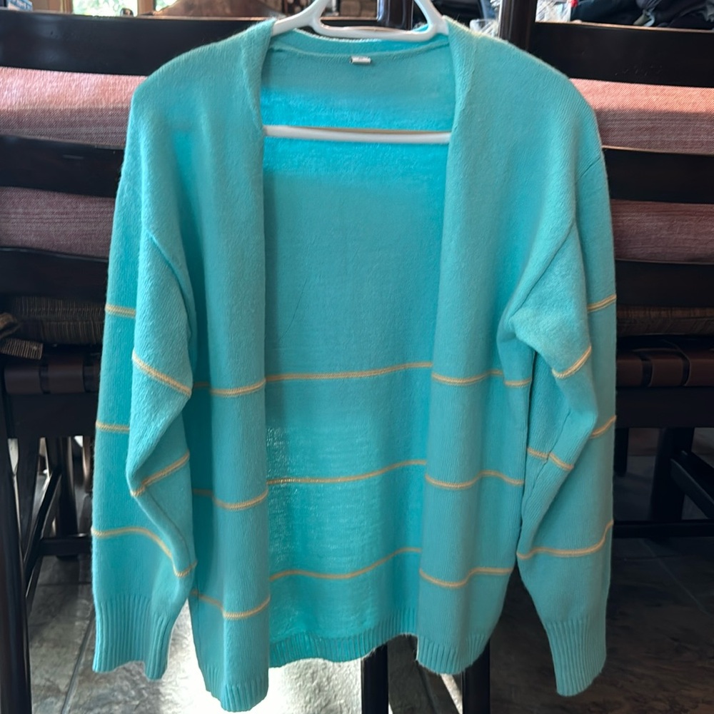 Beautiful blue cardigan with gold detail. Brand new never worn